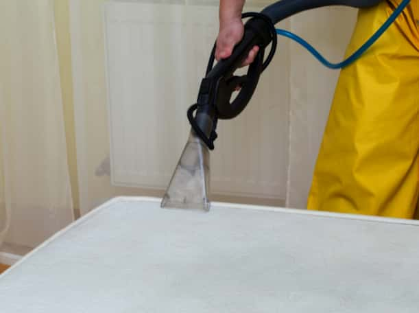 This is a photo of a man steam cleaning a dirty mattress works carried out by Ruislip Carpet Cleaning Solutions