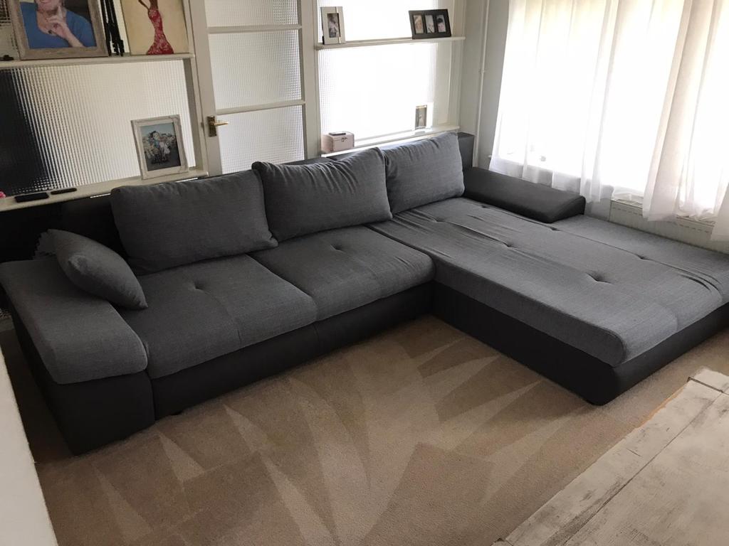 This is a photo of a grey L shape sofa that has been professionally steam cleaned, also the beige carpets have been steam cleaned too works carried out by Ruislip Carpet Cleaning Solutions