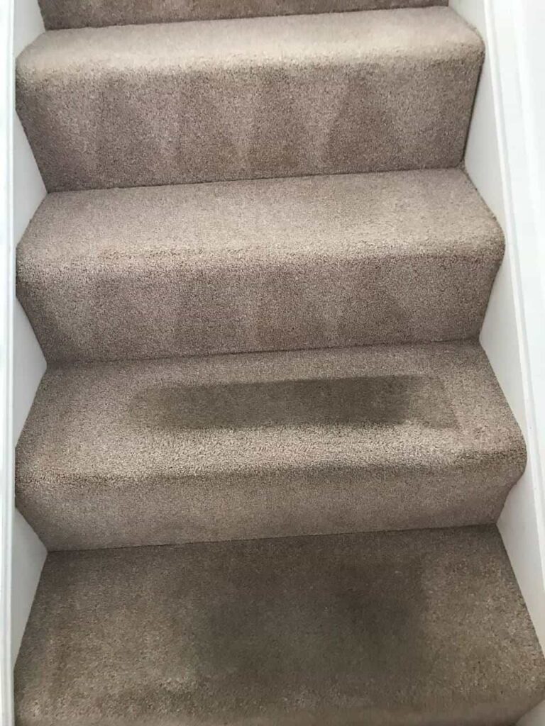 this is a photo of a staircase with beige carpets that is in the process of being cleaned works carried out by Ruislip Carpet Cleaning Solutions