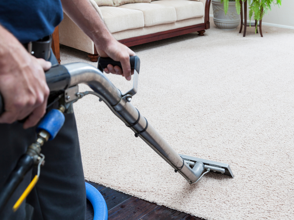 This is a photo of a man with a steam cleaner cleaning a cream carpet works carried out by Ruislip Carpet Cleaning Solutions